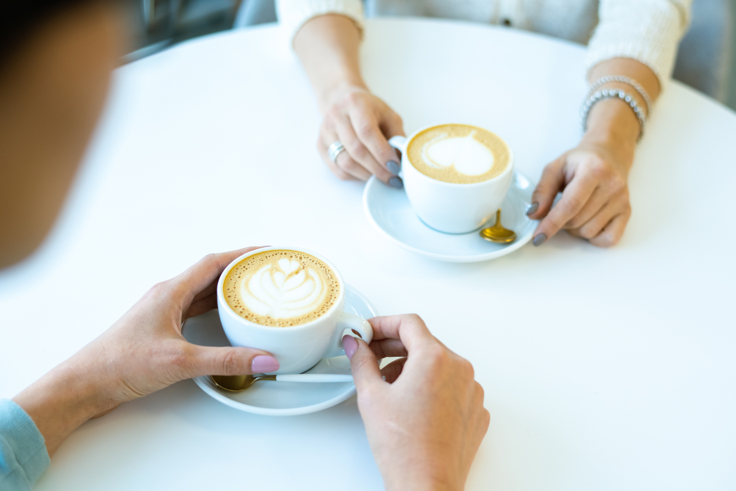 Friends Drinking Coffee Together in a Cafe